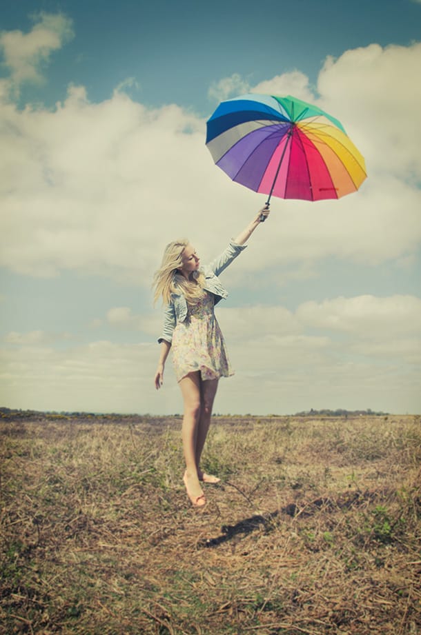 Levitating woman with rainbow umbrella 