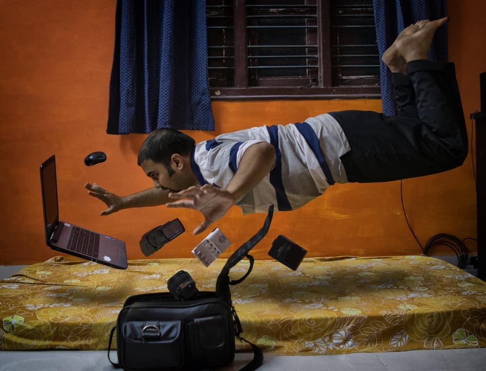Levitating man from the bed with computer