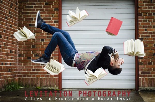 Levitating young man with books around him